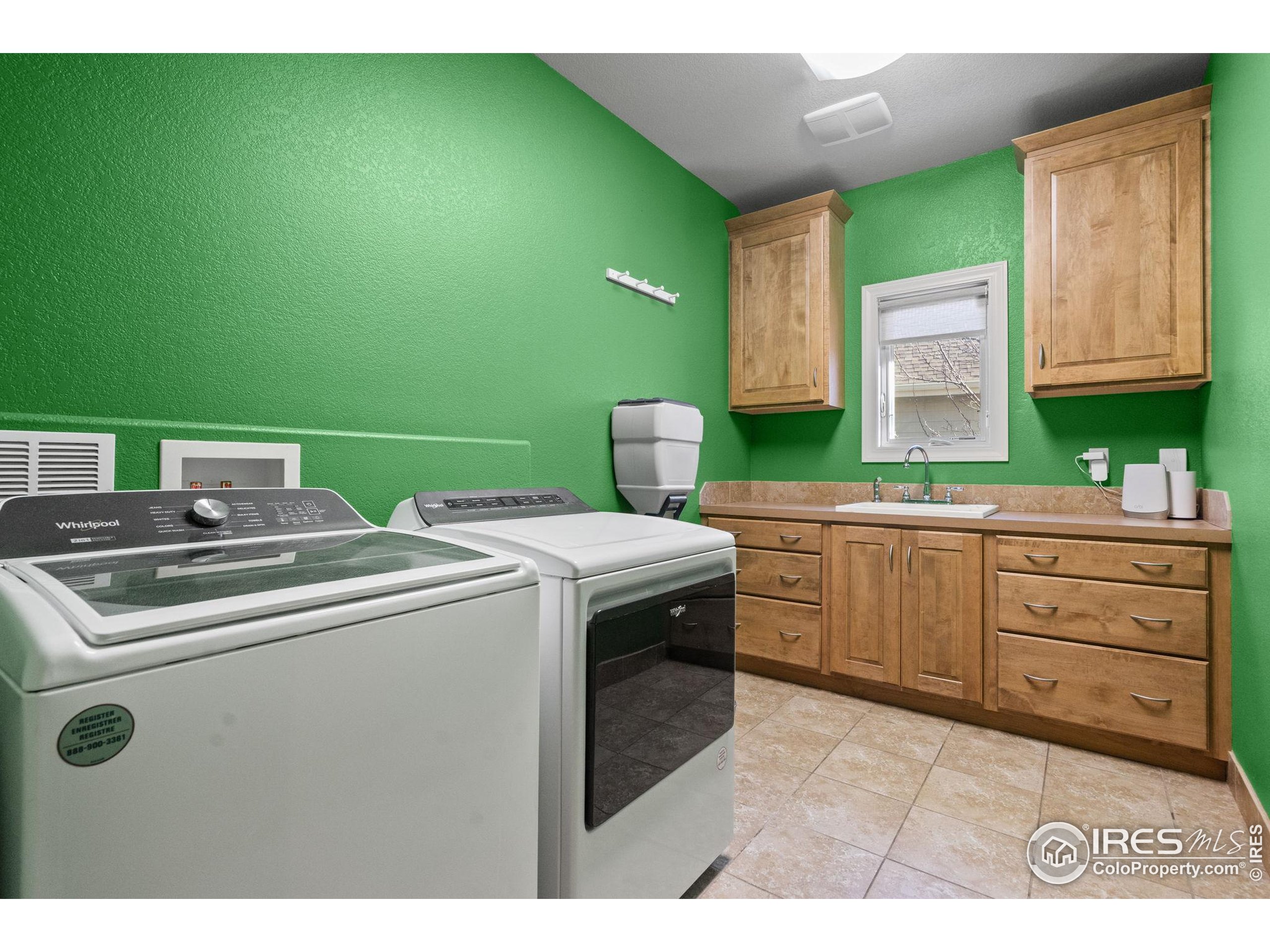 621 Roma Valley Drive Fort Collins, CO 80525 - Photo 26 of 50 a kitchen with a sink and a stove top oven