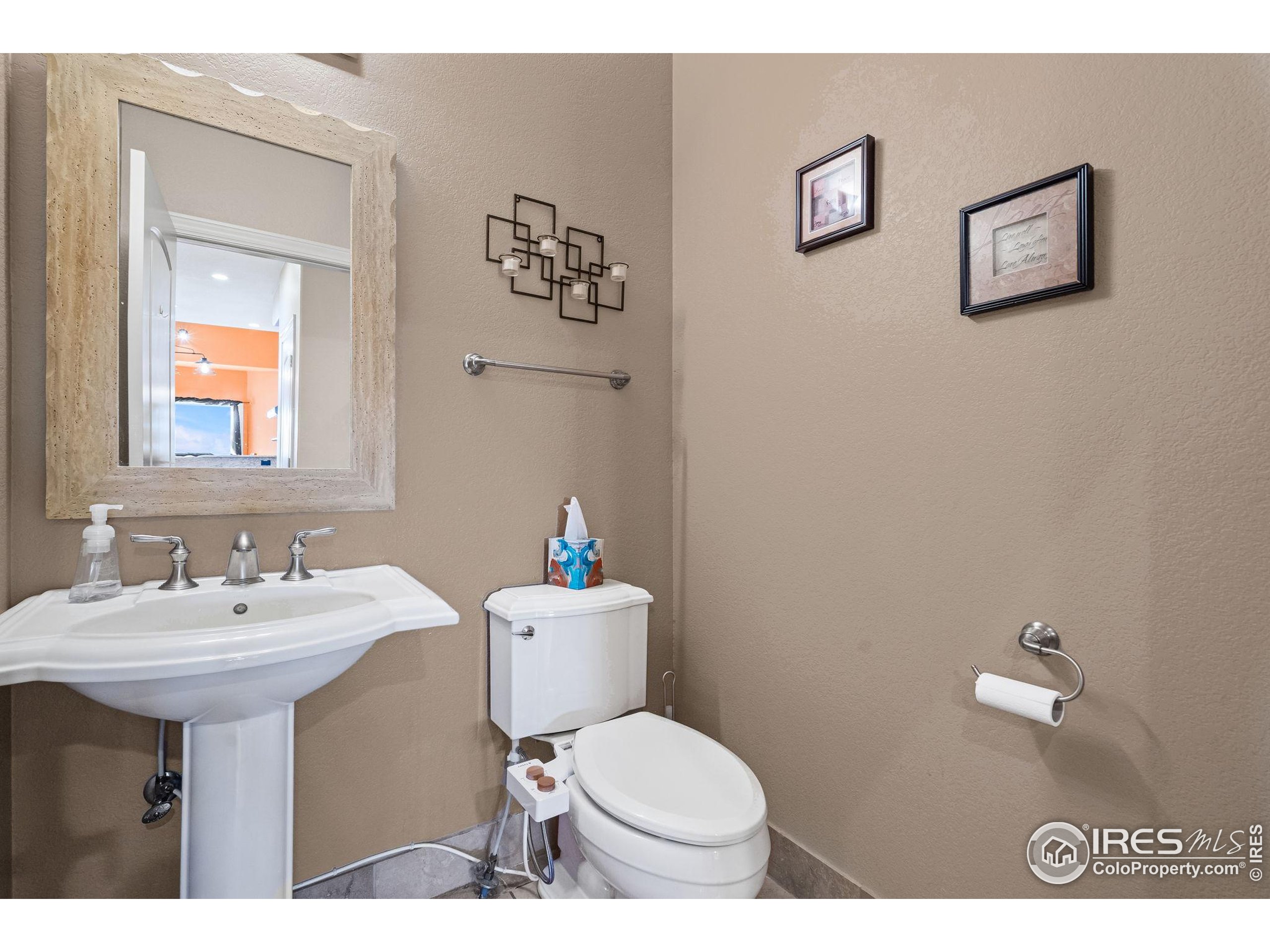 621 Roma Valley Drive Fort Collins, CO 80525 - Photo 27 of 50 a bathroom with a toilet sink and mirror