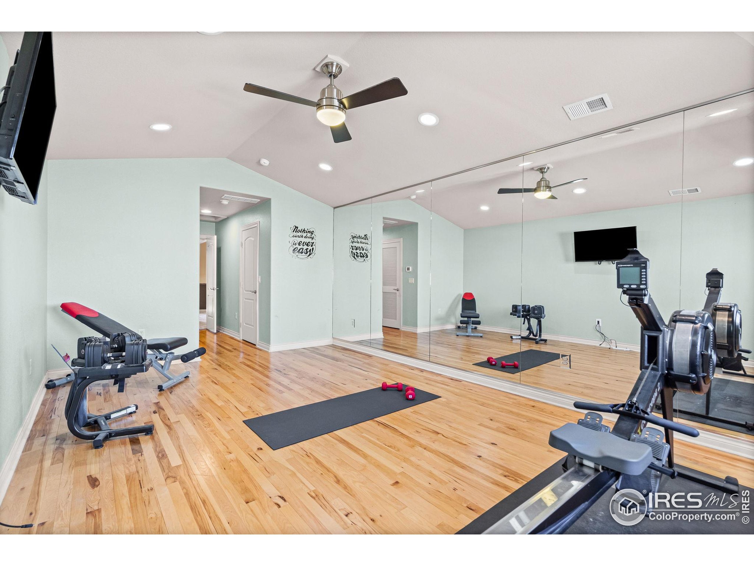 621 Roma Valley Drive Fort Collins, CO 80525 - Photo 30 of 50 a living room with furniture and a flat screen tv