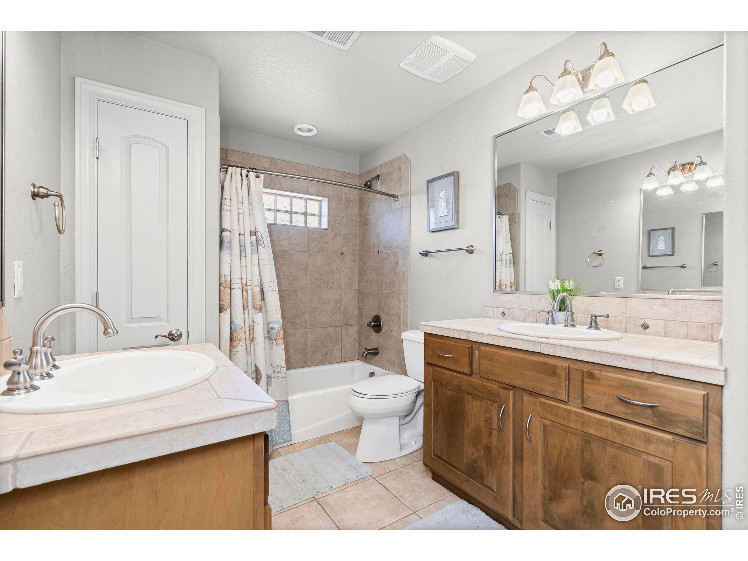 621 Roma Valley Drive Fort Collins, CO 80525 - Photo 33 of 50 a bathroom with a sink a toilet and a mirror
