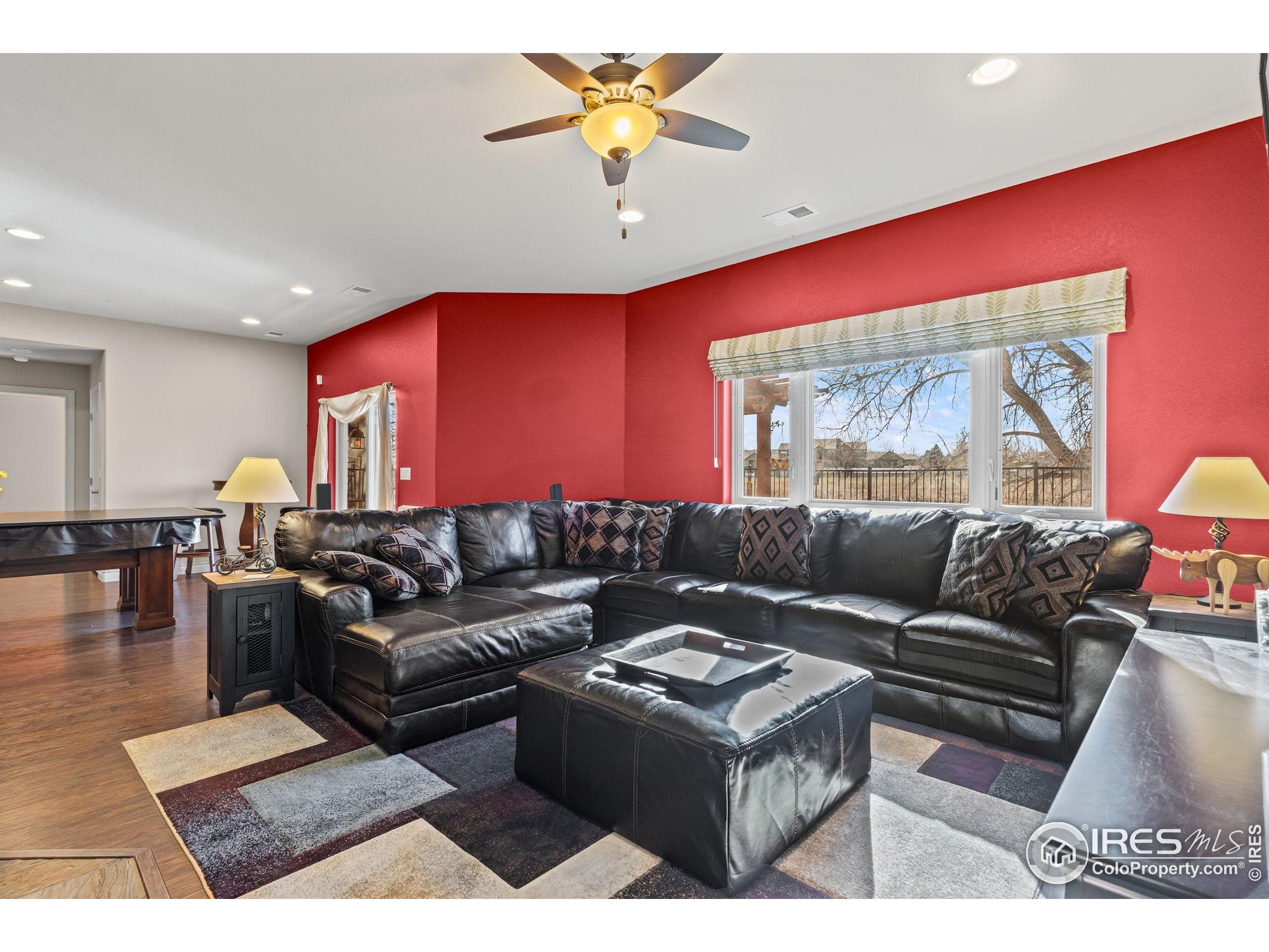 621 Roma Valley Drive Fort Collins, CO 80525 - Photo 37 of 50 a living room with furniture and a large window