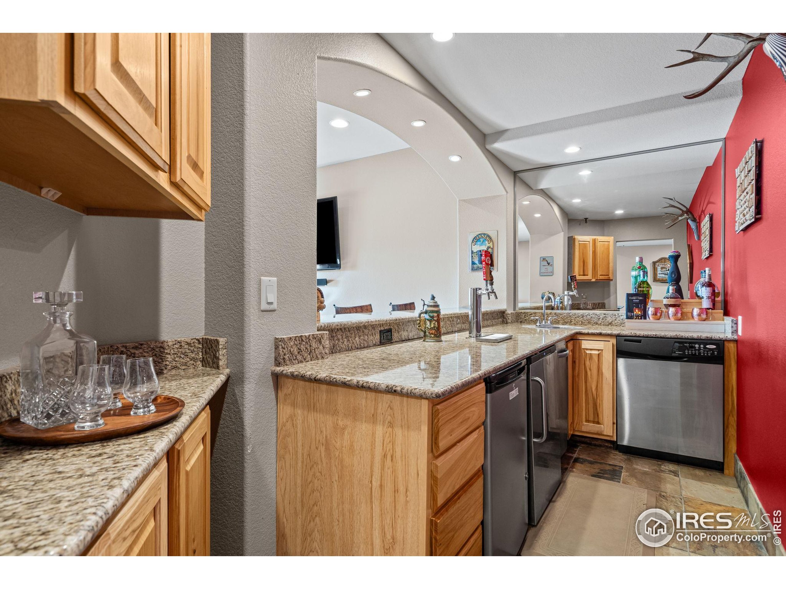 621 Roma Valley Drive Fort Collins, CO 80525 - Photo 40 of 50 a kitchen with stainless steel appliances granite countertop a sink and stove