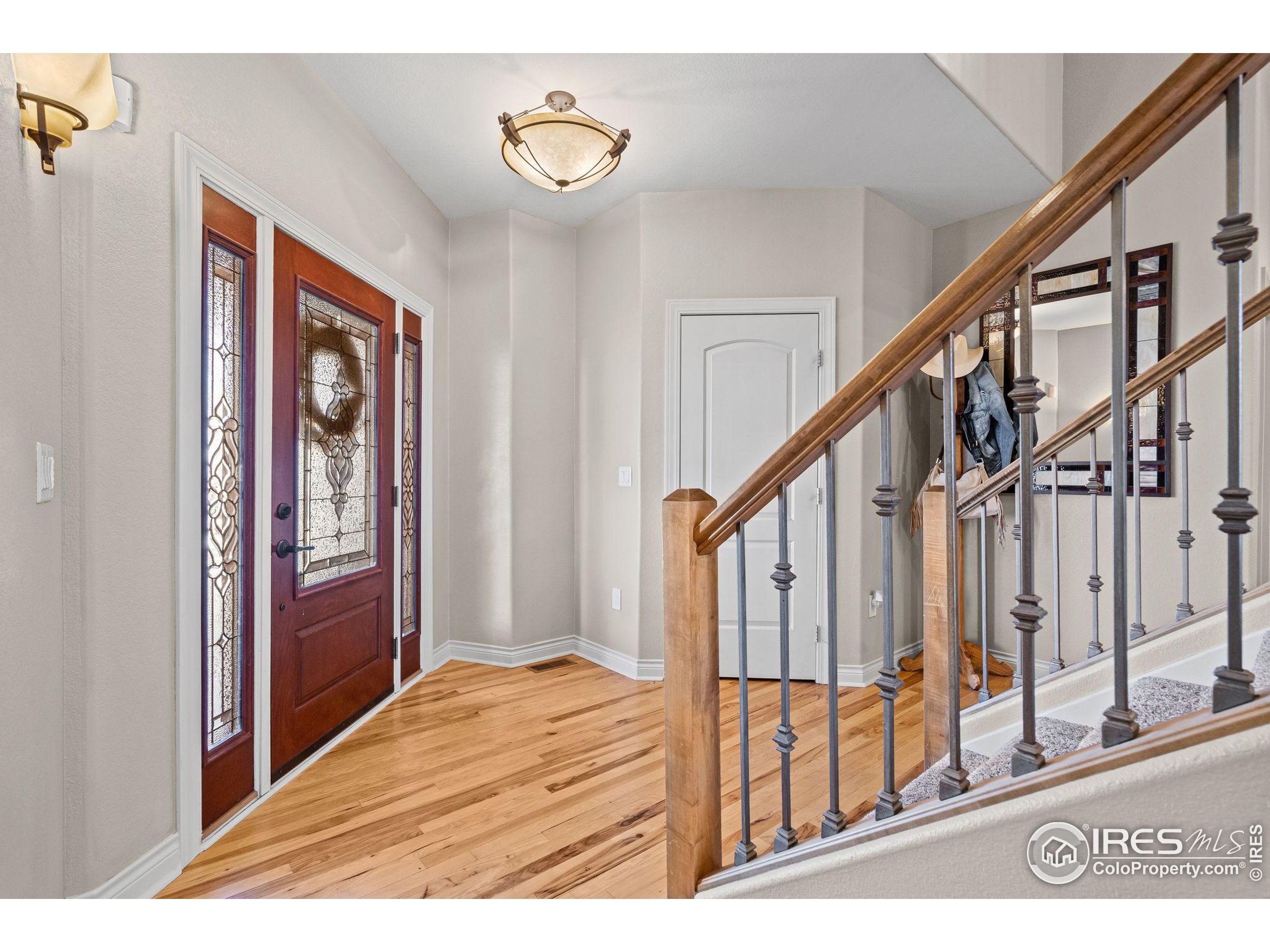 621 Roma Valley Drive Fort Collins, CO 80525 - Photo 4 of 50 a view of an entryway with wooden floor