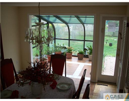 811 New Dover Road Edison, NJ 08820 - Photo 5 of 11 a view of a dining room with furniture window and outside view
