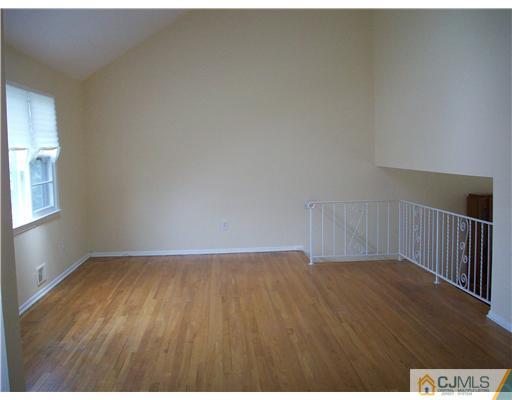 811 New Dover Road Edison, NJ 08820 - Photo 7 of 11 a view of an empty room and wooden floor