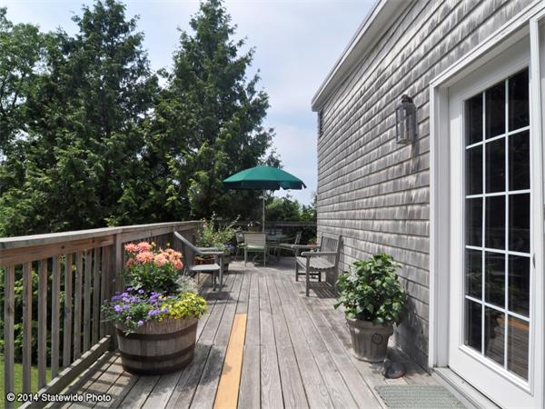 35 West Main Road Little Compton, RI 02837 - Photo 13 of 30 a view of a chair and table in the balcony with potted plants