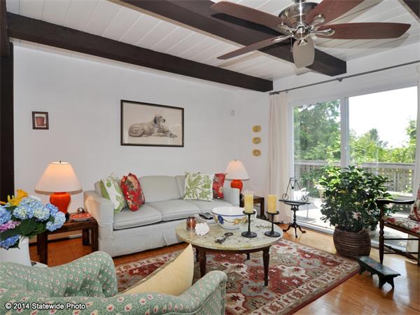 35 West Main Road Little Compton, RI 02837 - Photo 3 of 30 a living room with patio furniture and a potted plant