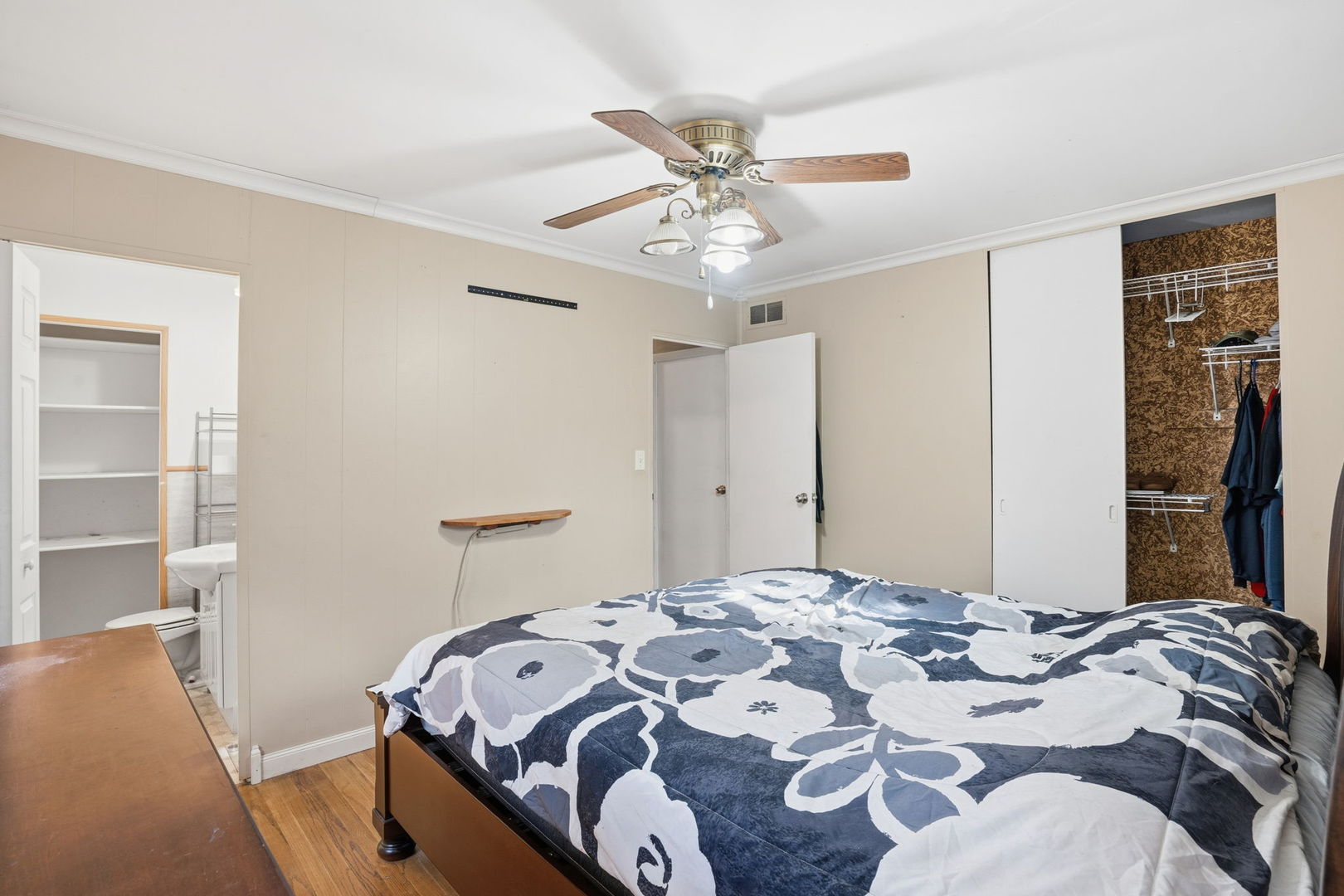 3900 28th Street Rock Island, IL 61201 - Photo 13 of 27 a bedroom with a bed and a chandelier