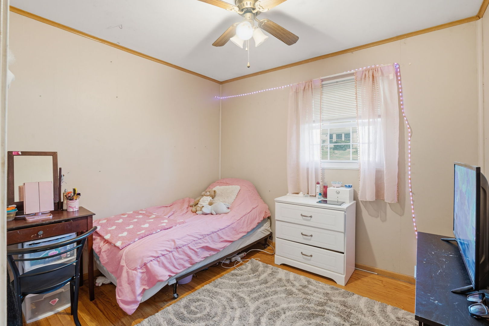 3900 28th Street Rock Island, IL 61201 - Photo 15 of 27 a bedroom with a bed and a flat tv screen on dresser