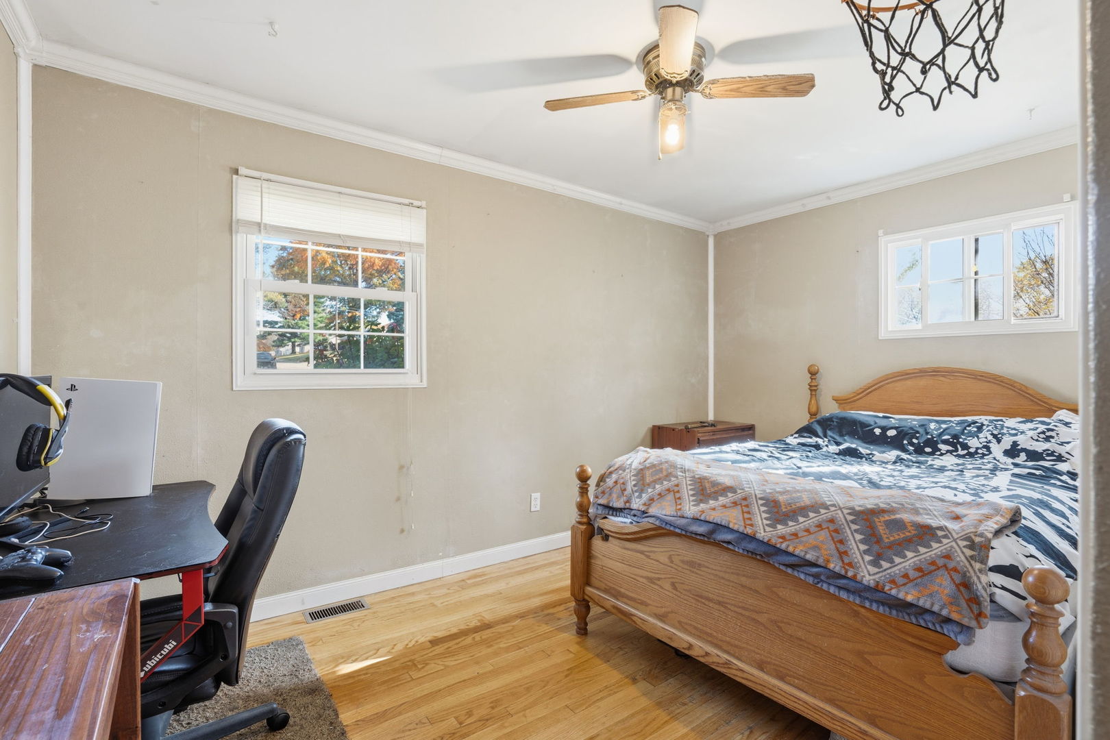 3900 28th Street Rock Island, IL 61201 - Photo 17 of 27 a bedroom with a bed a desk and chair with wooden floor