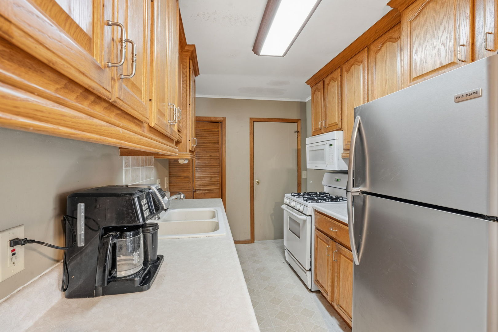 3900 28th Street Rock Island, IL 61201 - Photo 6 of 27 a kitchen with a refrigerator and a stove