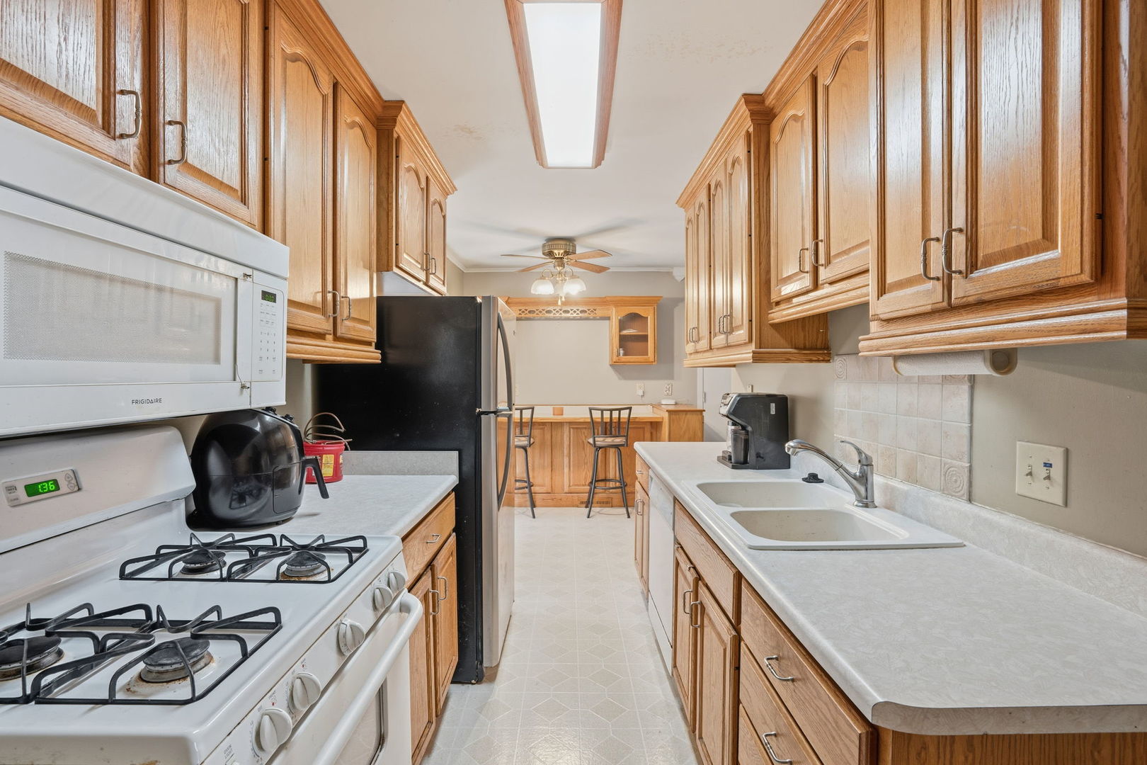 3900 28th Street Rock Island, IL 61201 - Photo 7 of 27 a kitchen with stainless steel appliances granite countertop a sink stove and refrigerator
