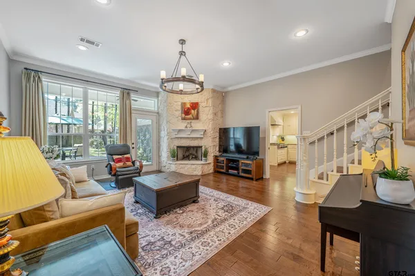 a living room with furniture a fireplace and wooden floor