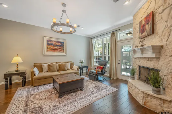 a living room with furniture a flat screen tv and a fireplace