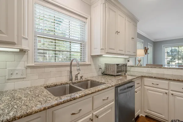 a stove top oven sitting inside of a kitchen