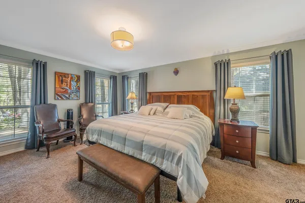 a bathroom with double vanity and a mirror