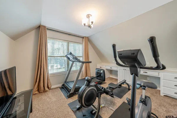 a kitchen with white cabinets and sink