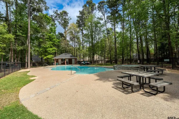 a view of swimming pool with a table and chairs