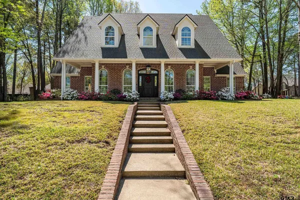 a hallway with wooden floor chandelier and entryway