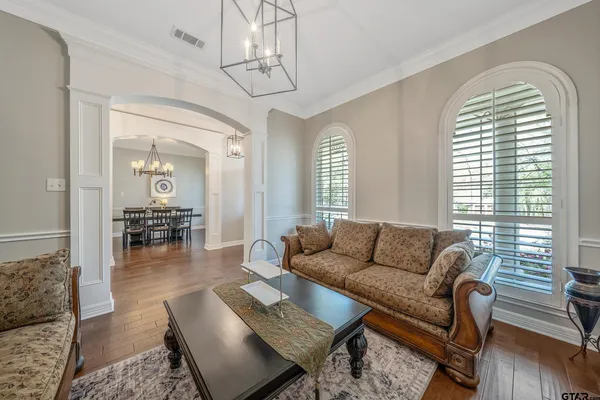 a living room with furniture chandelier and a window