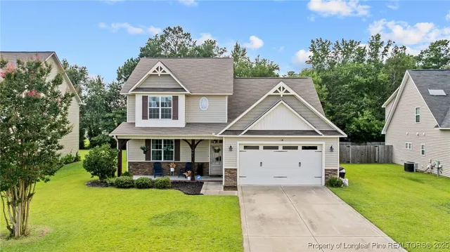 a view of house with garden and tall trees