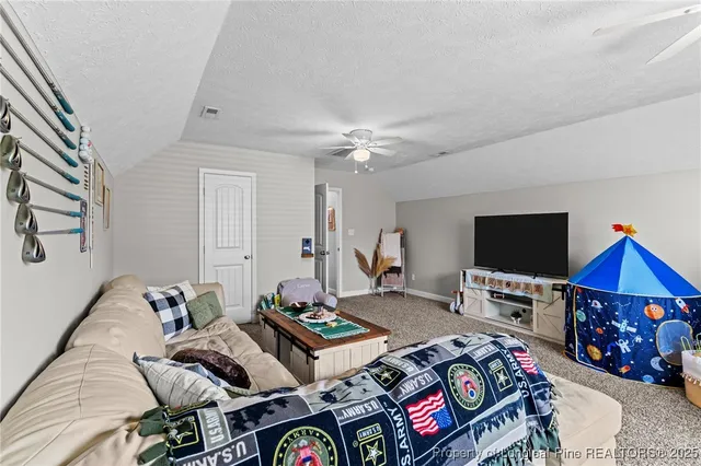 a bedroom with furniture and a flat screen tv