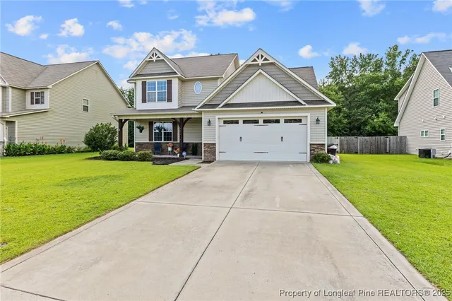 a view of a house with a yard and potted plants