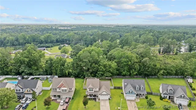 an aerial view of residential house with outdoor space and swimming pool