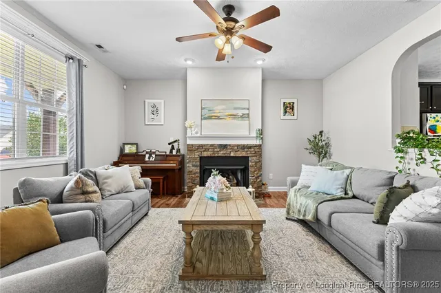 a living room with furniture a window and a fireplace