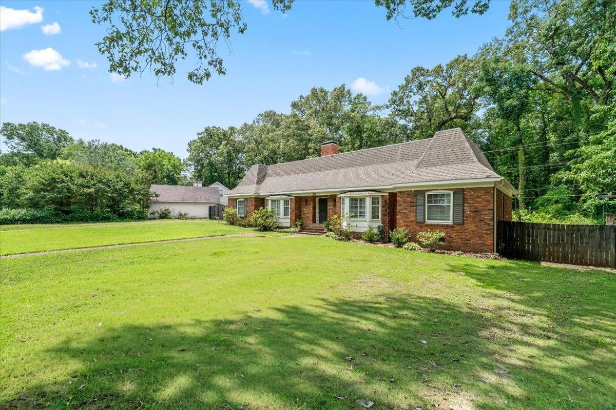 1273 Brookfield Road Memphis, TN 38119 - Photo 2 of 40 Brick exterior residence featuring a gabled roofline, bay window, and dark shutters