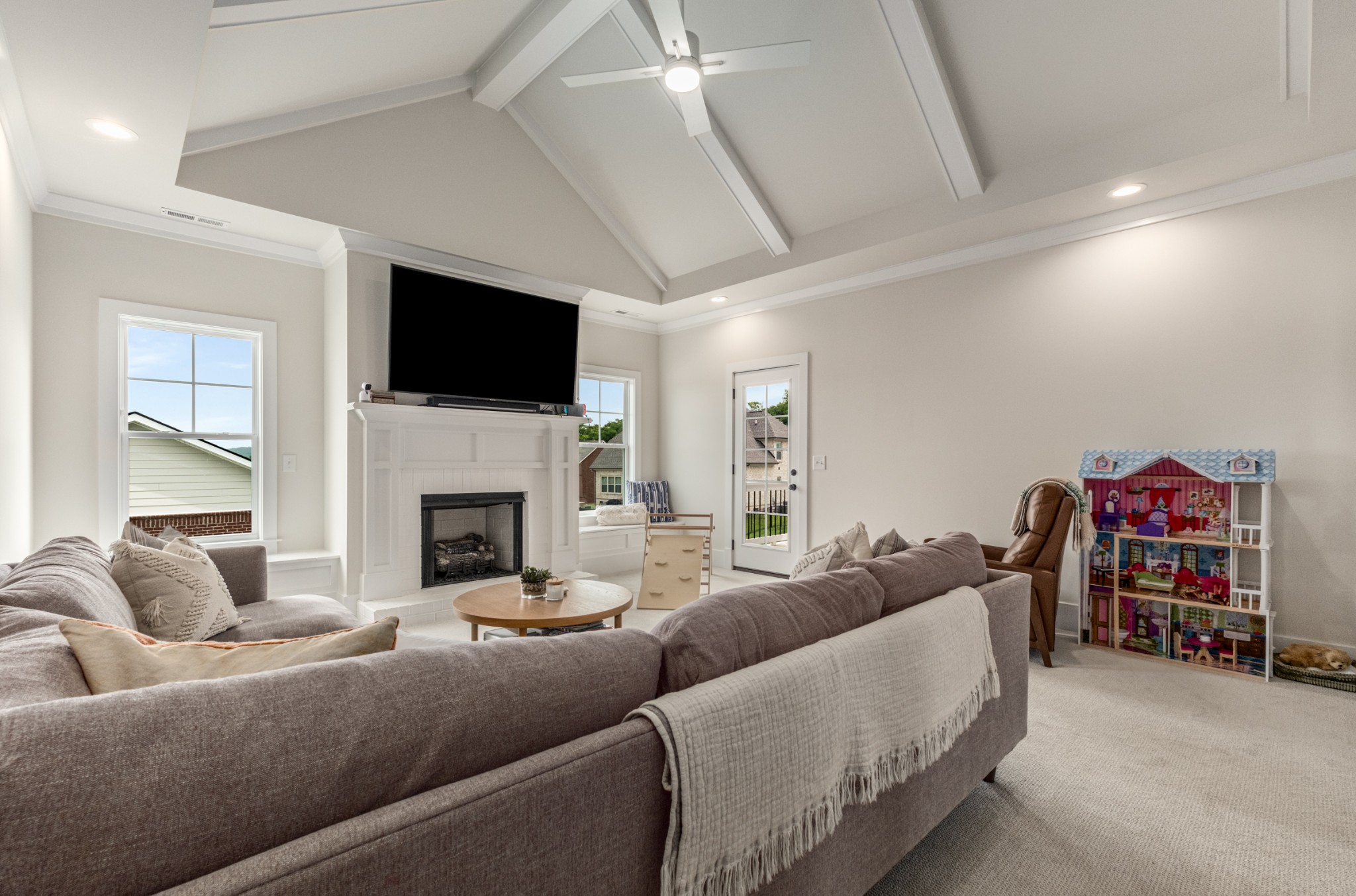 9011 Safehaven Place Spring Hill, TN 37174 - Photo 52 of 84 a living room with furniture a fireplace and a flat screen tv