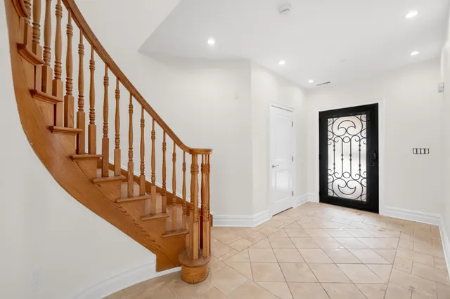 a view of an entryway with wooden floor