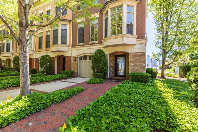 front view of a brick house with a yard