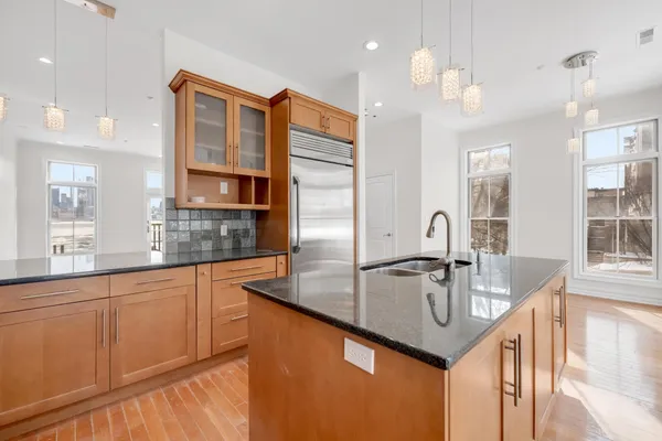 a kitchen with stainless steel appliances granite countertop a sink counter space and cabinets