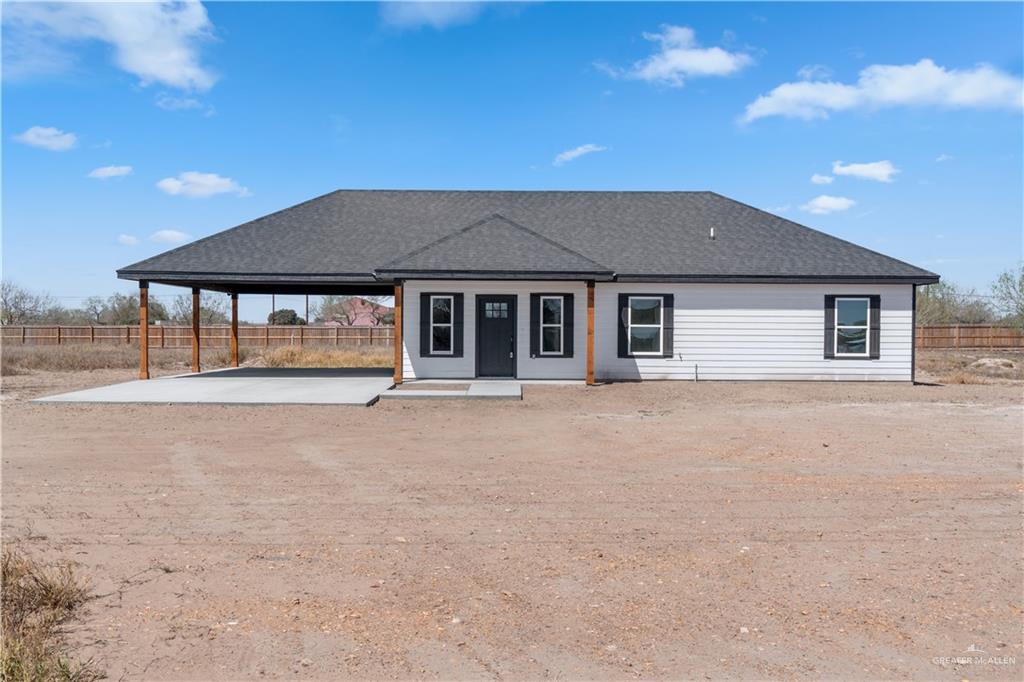 311 Other Road Rio Grande City, TX 78582 - Photo 1 of 16 View of front of home with covered porch, roof with shingles, an attached carport, and driveway