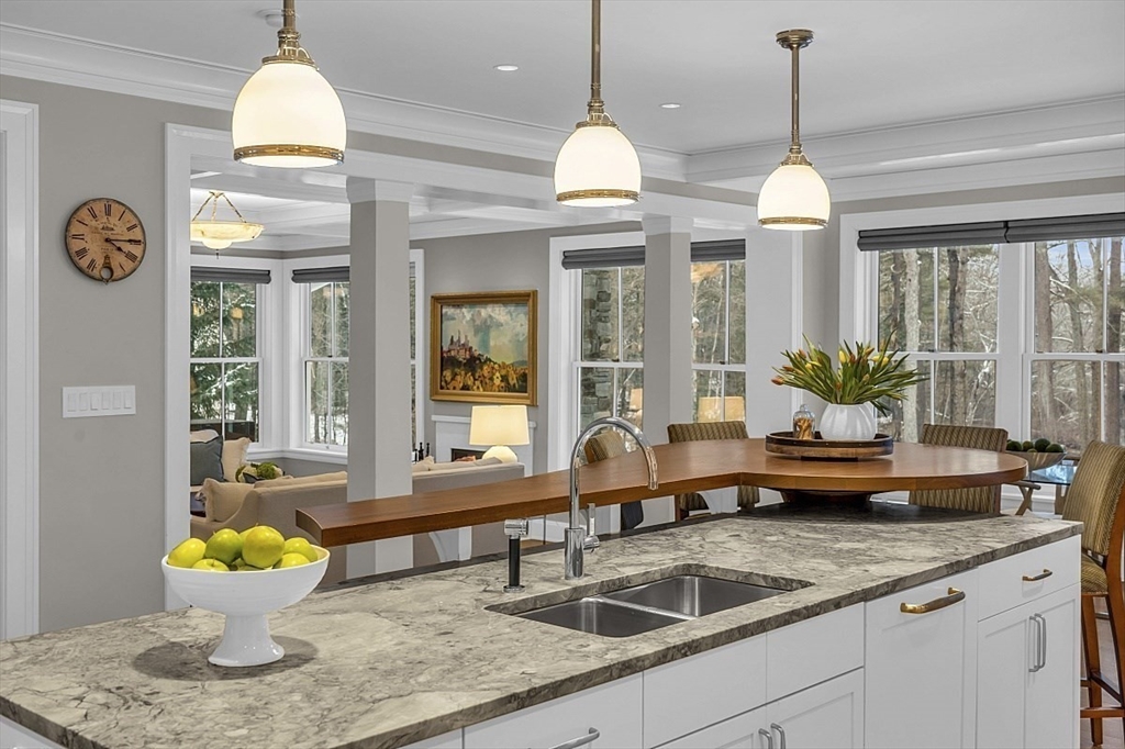 403 Simon Willard Road Concord, MA 01742 - Photo 16 of 42 a kitchen with a sink and a chandelier