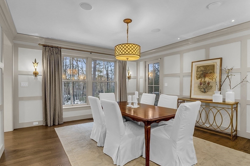 403 Simon Willard Road Concord, MA 01742 - Photo 19 of 42 a dining room with furniture a chandelier and wooden floor
