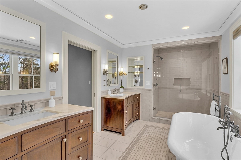 403 Simon Willard Road Concord, MA 01742 - Photo 27 of 42 a large bathroom with a double vanity sink mirror and bathtub