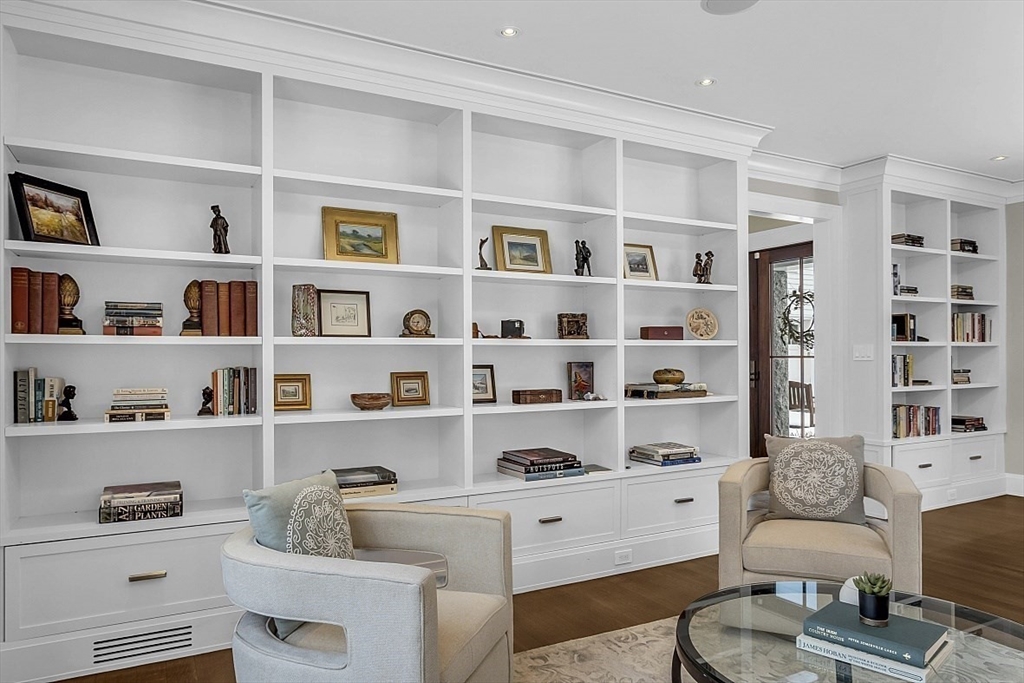 403 Simon Willard Road Concord, MA 01742 - Photo 8 of 42 a room with a furniture and a book shelf