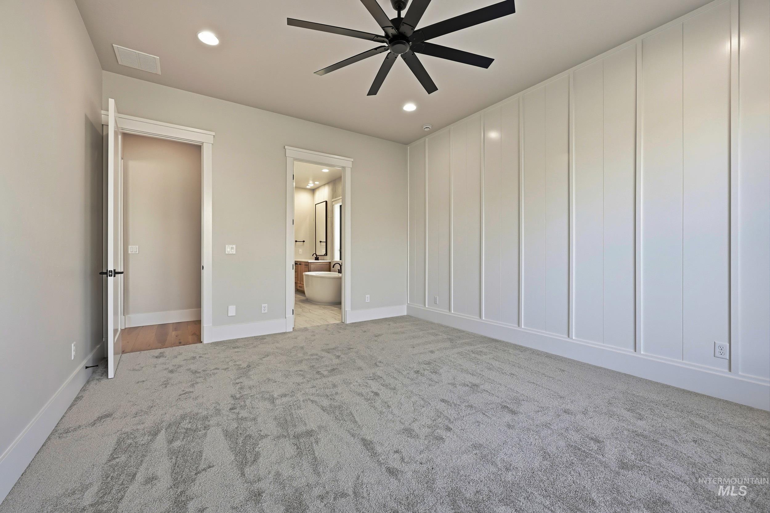 1048 East Escalation Street Meridian, ID 83642 - Photo 18 of 44 Unfurnished bedroom with ensuite bathroom, a ceiling fan, light colored carpet, and recessed lighting