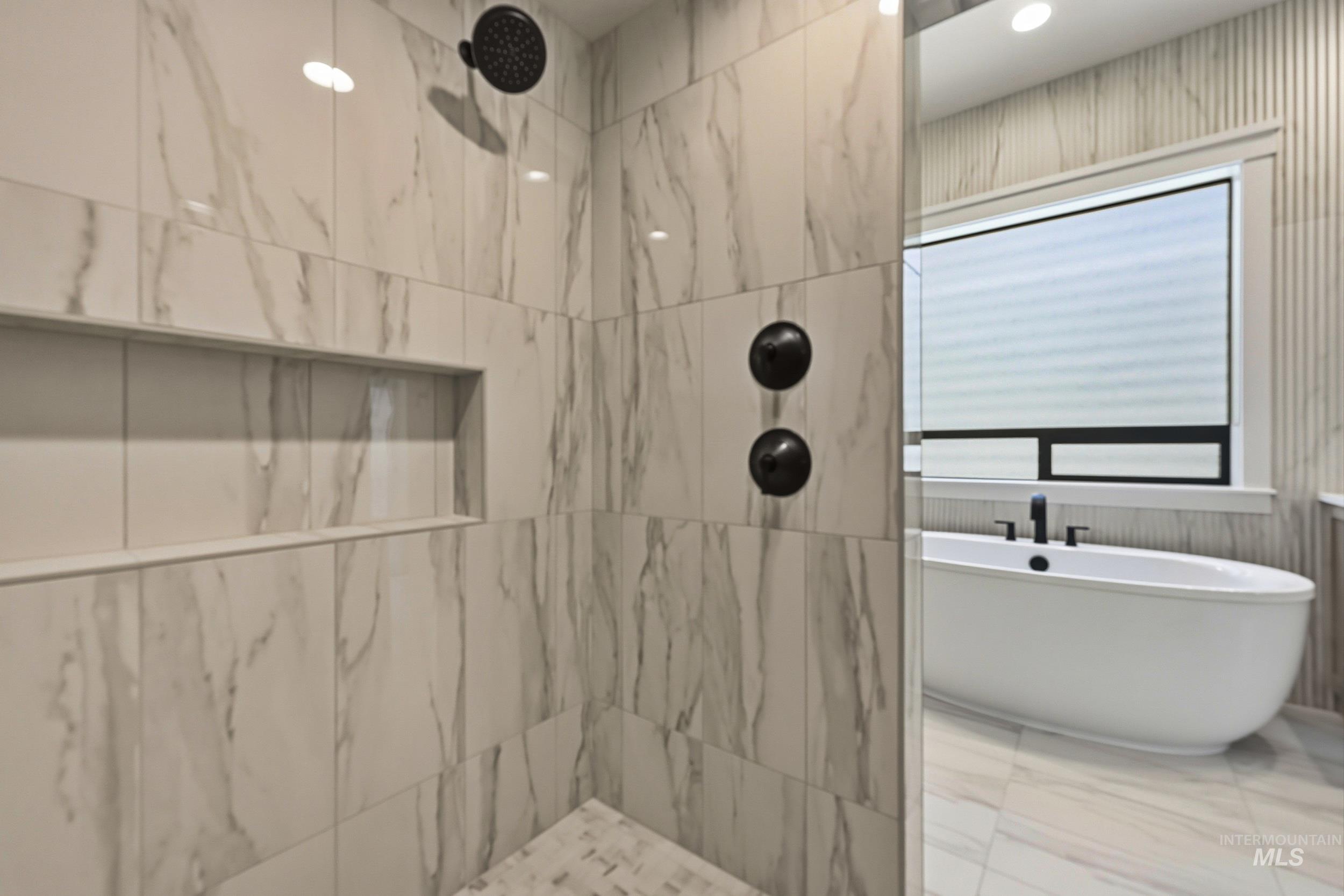 1048 East Escalation Street Meridian, ID 83642 - Photo 23 of 44 Full bathroom featuring a marble finish shower, a freestanding bath, marble look tiles, and recessed lighting