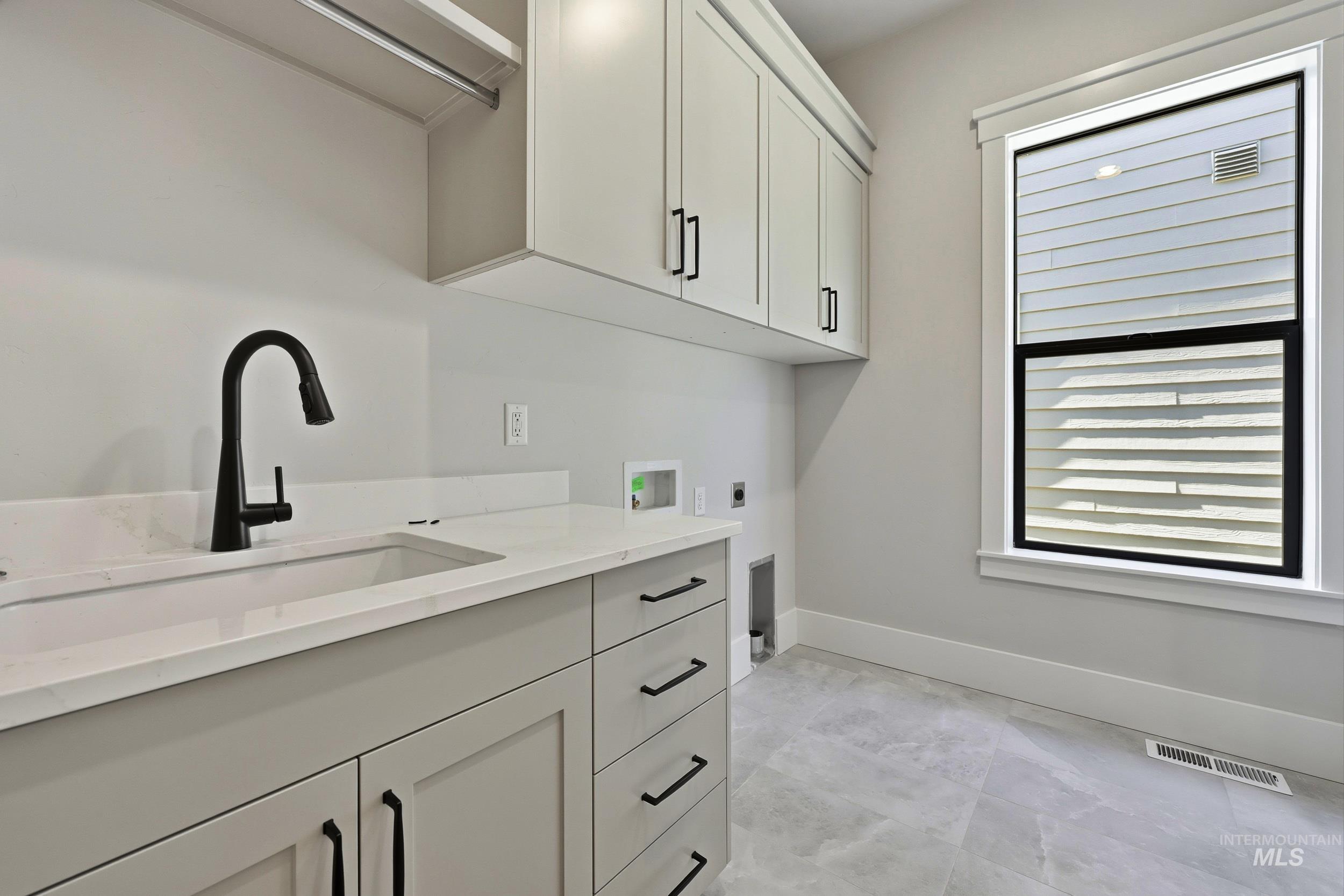 1048 East Escalation Street Meridian, ID 83642 - Photo 27 of 44 Laundry room with hookup for a washing machine, hookup for an electric dryer, and cabinet space