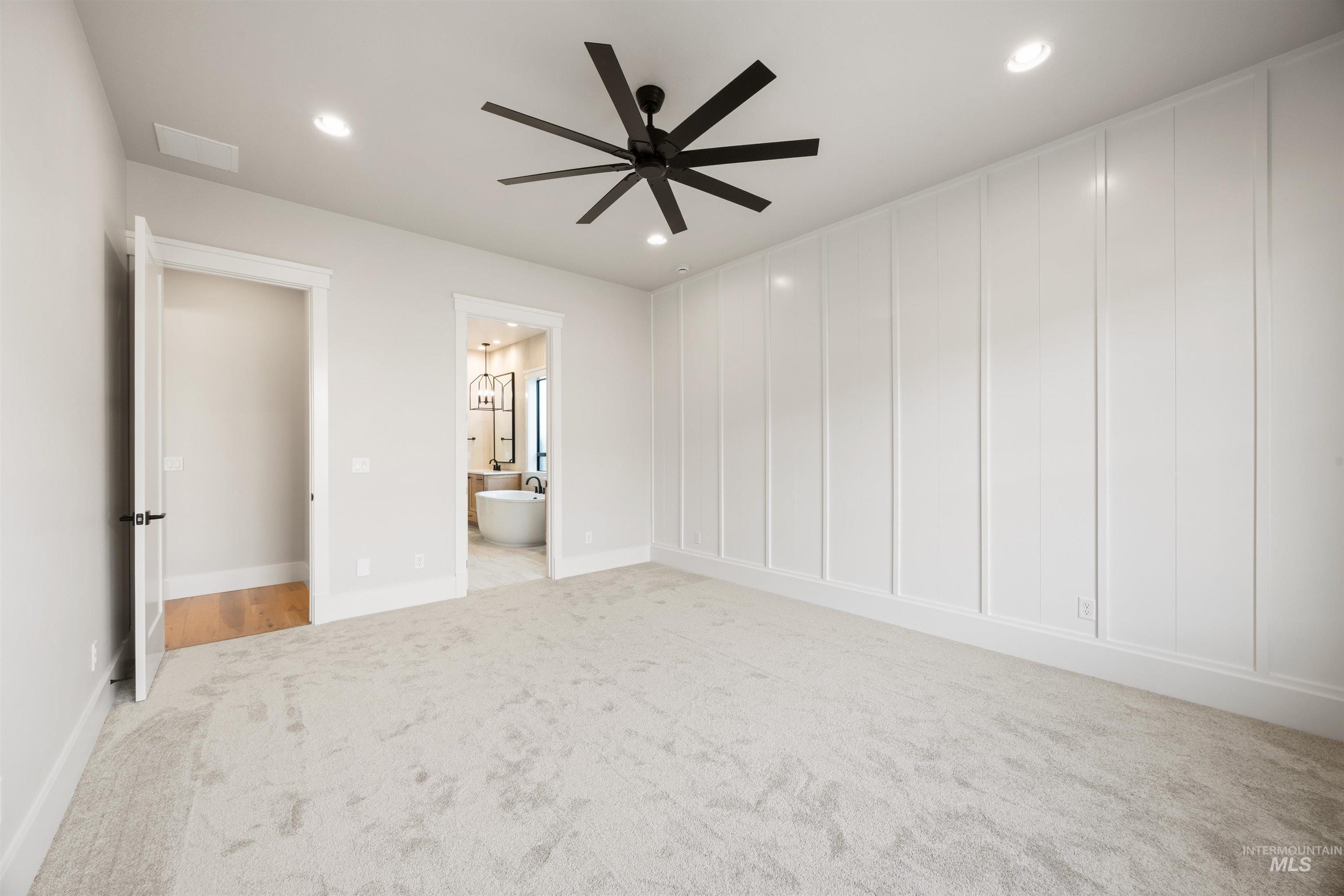 1048 East Escalation Street Meridian, ID 83642 - Photo 28 of 44 Unfurnished bedroom with light colored carpet, recessed lighting, ceiling fan, and ensuite bath