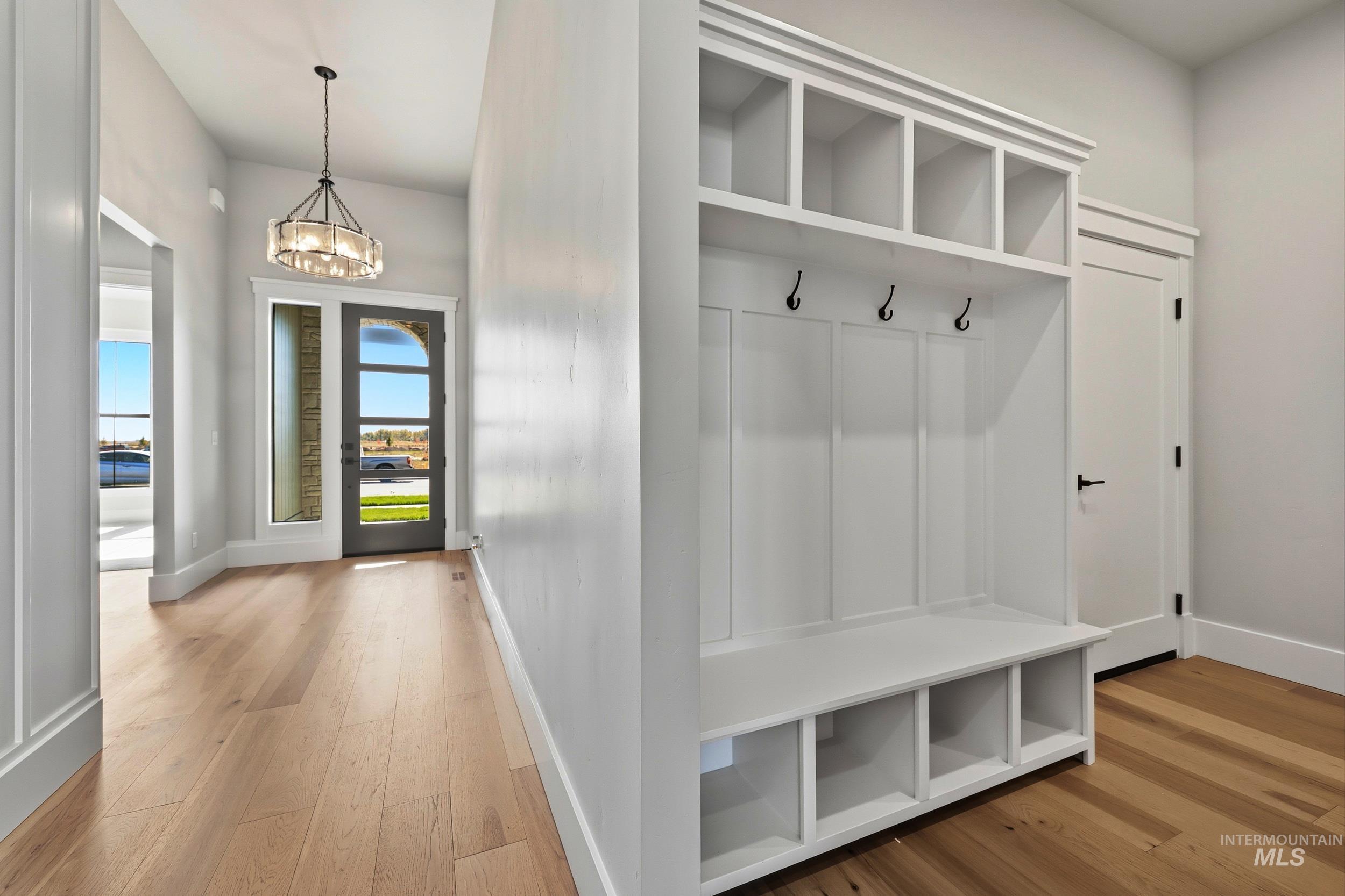 1048 East Escalation Street Meridian, ID 83642 - Photo 29 of 44 Mudroom featuring light wood-style floors and a chandelier