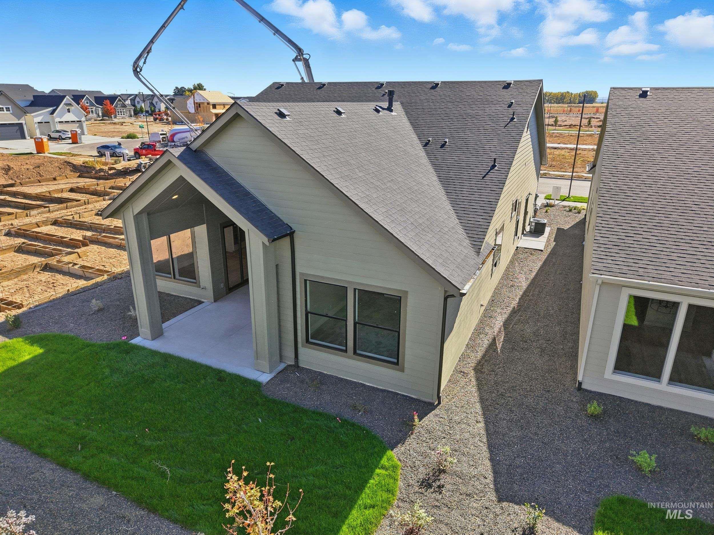 1048 East Escalation Street Meridian, ID 83642 - Photo 40 of 44 View of property exterior with a shingled roof, a patio, and a residential view