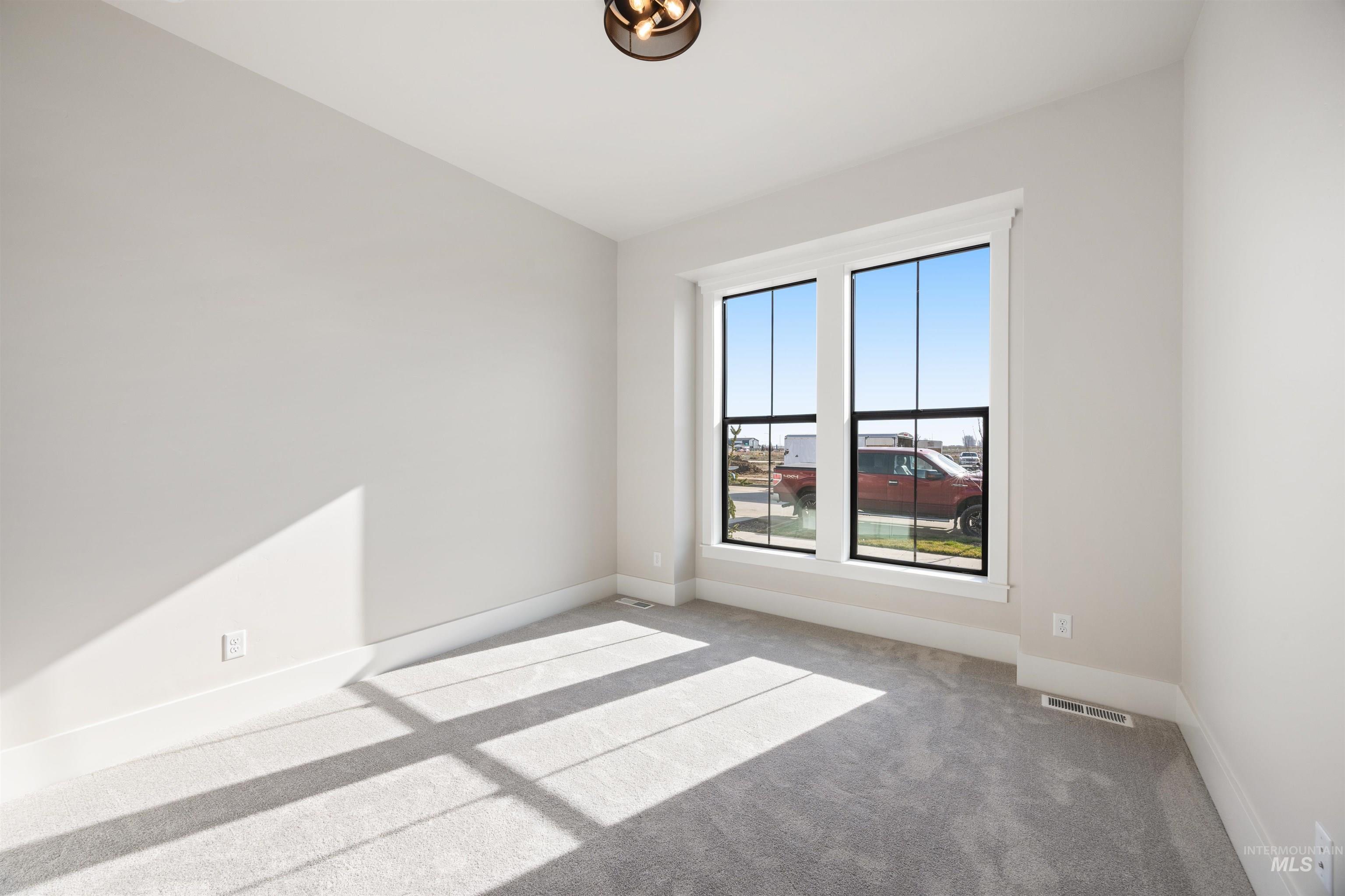 1048 East Escalation Street Meridian, ID 83642 - Photo 5 of 44 Carpeted empty room with baseboards