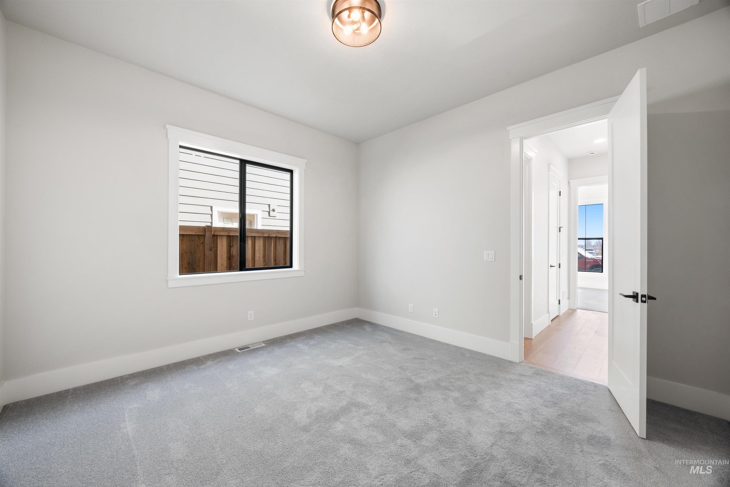 1048 East Escalation Street Meridian, ID 83642 - Photo 9 of 44 Empty room featuring light colored carpet and baseboards