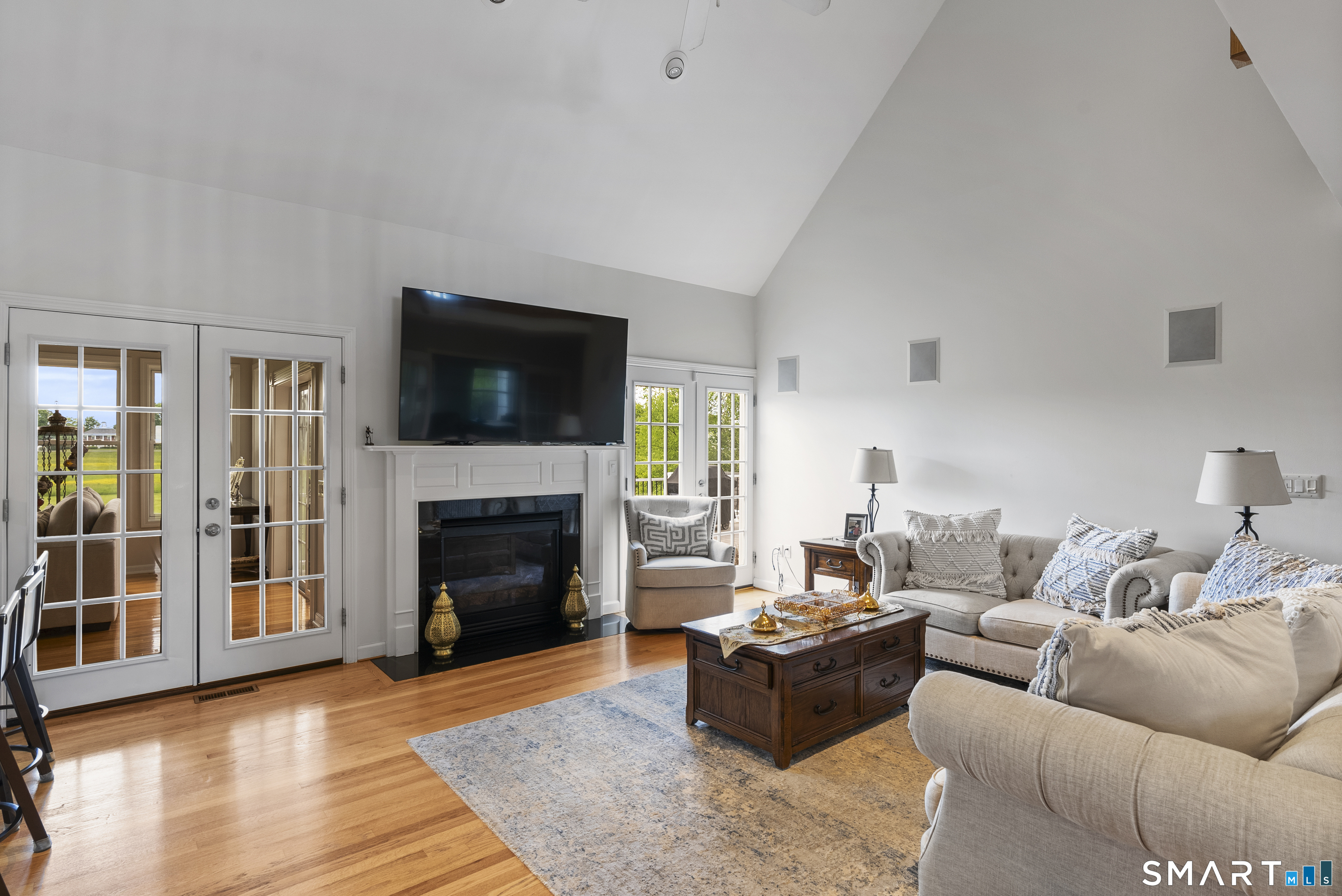 44 Farmstead Lane Suffield, CT 06078 - Photo 2 of 39 a living room with furniture a flat screen tv and a fireplace