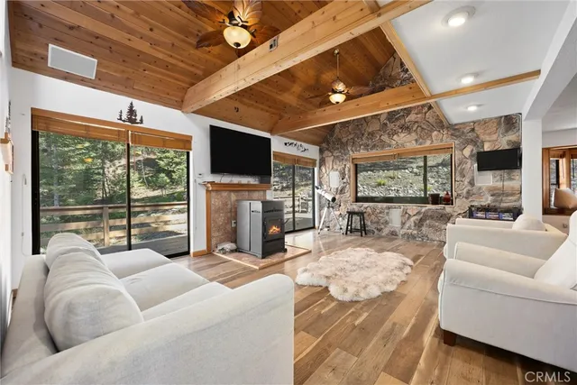 a living room with furniture a flat screen tv and a large window