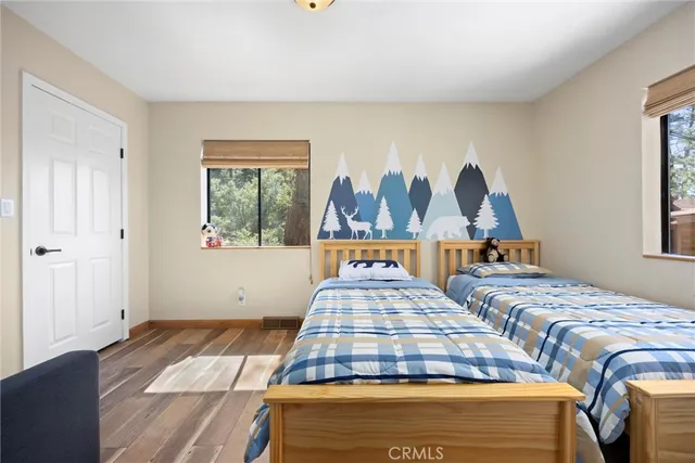 a bedroom with a large bed and a tv